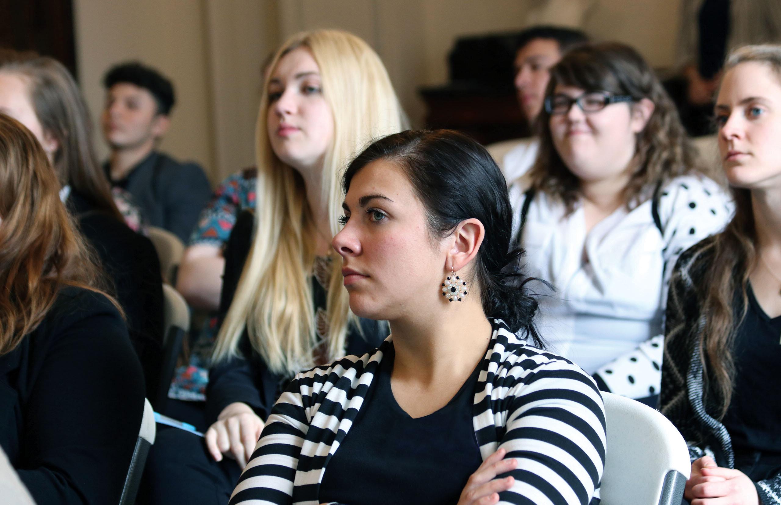 A group of students listening